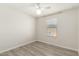 An empty bedroom with wood-look tile, a ceiling fan and natural light from a window at 2204 W Minton St, Phoenix, AZ 85041