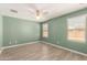 Green bedroom featuring tile floors, two windows, and a ceiling fan at 2204 W Minton St, Phoenix, AZ 85041