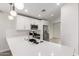 Close-up of a modern kitchen with stainless steel appliances, white cabinets, and a quartz countertop at 2204 W Minton St, Phoenix, AZ 85041