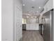 Well-lit kitchen featuring stainless steel appliances, white cabinets, and wood-look tile flooring at 2204 W Minton St, Phoenix, AZ 85041