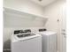 A laundry room featuring a white washer, dryer and a shelf at 2204 W Minton St, Phoenix, AZ 85041