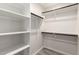 Organized walk-in closet with shelves and rods for storage at 2204 W Minton St, Phoenix, AZ 85041