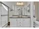 Bathroom with double sinks, white cabinetry, walk-in shower, and large mirror at 2263 N Trekell Rd # 113, Casa Grande, AZ 85122