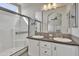 Bathroom with double sinks, white cabinetry, walk-in shower, and large mirror at 2263 N Trekell Rd # 113, Casa Grande, AZ 85122