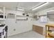 An oversized garage featuring storage shelves, work table, and air conditioning at 2263 N Trekell Rd # 113, Casa Grande, AZ 85122