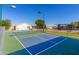 Brightly lit pickleball courts with green and blue surfaces offer an active recreational amenity at 2263 N Trekell Rd # 113, Casa Grande, AZ 85122