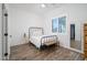 Bright bedroom featuring hardwood floors, shuttered windows, and a modern ceiling fan at 23420 S 202Nd St, Queen Creek, AZ 85142