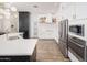 Modern kitchen with white cabinets, stainless steel appliances, subway tile backsplash, and dark countertops at 23420 S 202Nd St, Queen Creek, AZ 85142