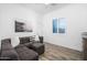 Cozy sitting area with a comfortable couch, ample seating, and soft light filtering through shuttered windows at 23420 S 202Nd St, Queen Creek, AZ 85142