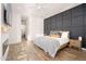 Serene main bedroom with a wood-accent wall, stylish decor, and ample space, creating a peaceful retreat at 23420 S 202Nd St, Queen Creek, AZ 85142