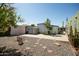 Cozy backyard featuring stone landscaping, a charming shed, and lush greenery, creating a serene outdoor space at 2528 E Mckellips Rd # 74, Mesa, AZ 85213