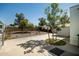 Spacious backyard with gravel landscaping, trees, and plenty of space for outdoor activities at 2528 E Mckellips Rd # 74, Mesa, AZ 85213