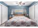 Bedroom featuring blue walls, two windows, and a ceiling fan at 2528 E Mckellips Rd # 74, Mesa, AZ 85213