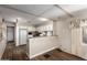 Bright kitchen featuring white cabinets, laminate countertops, and wood-look vinyl flooring at 2528 E Mckellips Rd # 74, Mesa, AZ 85213