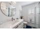 Bright bathroom featuring a modern vanity, round mirror, and walk-in shower for a clean, updated look at 2608 Leisure World --, Mesa, AZ 85206