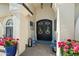 Inviting front entrance featuring double doors, decorative wreath, and colorful potted plants at 2608 Leisure World --, Mesa, AZ 85206