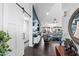 Open-concept living room with dark flooring, a white barn door, and stylish decor at 2608 Leisure World --, Mesa, AZ 85206