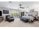 Elegant main bedroom featuring a ceiling fan, plush seating, and large windows for natural light at 2608 Leisure World --, Mesa, AZ 85206