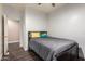 Cozy bedroom with dark wood floors features neutral colored walls and is adjacent to another room at 2635 E Chester Dr, Chandler, AZ 85286