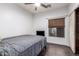 Bedroom features wood floors, a ceiling fan, a window with blinds, a closet and fresh white walls at 2635 E Chester Dr, Chandler, AZ 85286