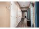 Hallway with wood floors leads to the bedrooms and bathrooms and features a woven storage basket at 2635 E Chester Dr, Chandler, AZ 85286