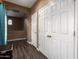 Hallway featuring laminate wood flooring and multiple storage closet doors at 2635 E Chester Dr, Chandler, AZ 85286