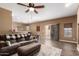 Open-concept living room with a ceiling fan, sliding glass door, and view to the kitchen at 2635 E Chester Dr, Chandler, AZ 85286