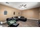 Comfortable living room features a ceiling fan and dark brown faux-wood floors at 2635 E Chester Dr, Chandler, AZ 85286