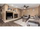 Comfortable living room features a cozy fireplace, laminate flooring, and neutral color scheme at 2635 E Chester Dr, Chandler, AZ 85286