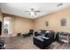 Cozy living room offers faux-wood flooring, a ceiling fan, and ample natural light at 2635 E Chester Dr, Chandler, AZ 85286