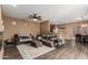 Inviting living room with dark brown laminate floors and neutral walls with a pass-through bar to kitchen at 2635 E Chester Dr, Chandler, AZ 85286