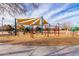 Playground with swings and climbing structures, covered by a sunshade, ensuring fun in a safe environment at 2635 E Chester Dr, Chandler, AZ 85286