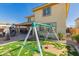 Large backyard featuring patio, playset, and plenty of room to play at 2748 E Cherry Hill Dr, Gilbert, AZ 85298