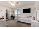 Bright, carpeted bedroom featuring a ceiling fan and a window overlooking the neighborhood at 2748 E Cherry Hill Dr, Gilbert, AZ 85298