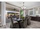 Open dining area with patio access, showcasing chandelier lighting and unique upholstered chairs around a table at 2748 E Cherry Hill Dr, Gilbert, AZ 85298