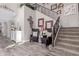 Bright foyer with staircase, iron railing, decor, and a decorative console table with complementary armchairs at 2748 E Cherry Hill Dr, Gilbert, AZ 85298