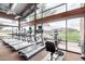 Fitness center overlooking lake featuring treadmills, elliptical, and exercise bike with scenic outdoor views at 2748 E Cherry Hill Dr, Gilbert, AZ 85298