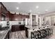 Well-lit kitchen featuring stainless appliances, granite countertops, a spacious island, and stylish barstool seating at 2748 E Cherry Hill Dr, Gilbert, AZ 85298