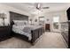 Well-lit bedroom with carpet, ceiling fan, dark wood furniture, and a door to the backyard at 2748 E Cherry Hill Dr, Gilbert, AZ 85298