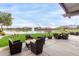 Outdoor patio seating area overlooking a serene pond with fountain and surrounding neighborhood homes at 2748 E Cherry Hill Dr, Gilbert, AZ 85298