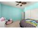 Bright bedroom features ceiling fan, soft carpet, and slider closet doors at 2811 W Glenhaven Dr, Phoenix, AZ 85045