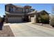 Charming two-story home with a three-car garage, desert landscaping, and neutral stucco exterior at 2811 W Glenhaven Dr, Phoenix, AZ 85045