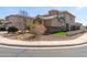 View of a tan two-story home highlighting stone accents and desert landscaping for low-maintenance appeal at 2811 W Glenhaven Dr, Phoenix, AZ 85045