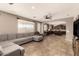 Open-concept living room with tile flooring and seamless flow into the kitchen at 2811 W Glenhaven Dr, Phoenix, AZ 85045