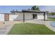 Modern back patio features a sleek overhang, artificial turf, and easy access from the living area at 2925 E North Ln, Phoenix, AZ 85028