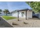 Backyard featuring a covered patio, artificial grass, and gravel landscaping at 2925 E North Ln, Phoenix, AZ 85028