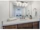 Bright bathroom features a vanity with modern lighting, quartz counters, and dark wood cabinetry at 2925 E North Ln, Phoenix, AZ 85028