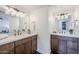 Bright bathroom features a double vanity with modern lighting, quartz counters, and dark wood cabinetry at 2925 E North Ln, Phoenix, AZ 85028