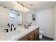 Double vanity in bathroom with wood cabinets, white quartz countertop, and black fixtures at 2925 E North Ln, Phoenix, AZ 85028