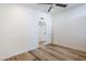 Bright bedroom with wood floors, ceiling fan and a doorway leading to another room at 2925 E North Ln, Phoenix, AZ 85028